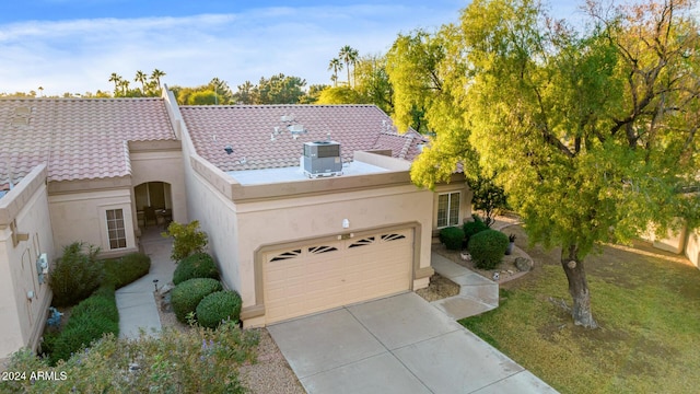 view of front facade with central AC and a garage