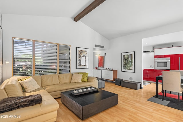 4800 N 68th St Unit 114, Scottsdale, AZ 85251 - living room featuring light wood finished floors, beam ceiling, and high vaulted ceiling