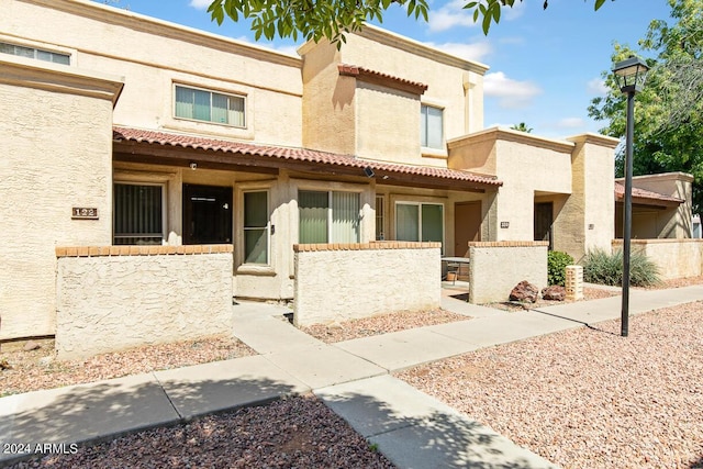 view of front of property with stucco siding and fence