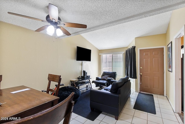 living area with light tile patterned floors, ceiling fan, a textured ceiling, and lofted ceiling