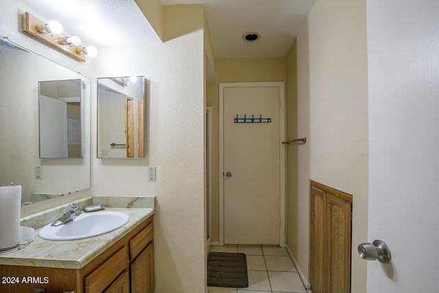 bathroom with tile patterned floors and vanity