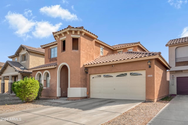 mediterranean / spanish-style house with a garage