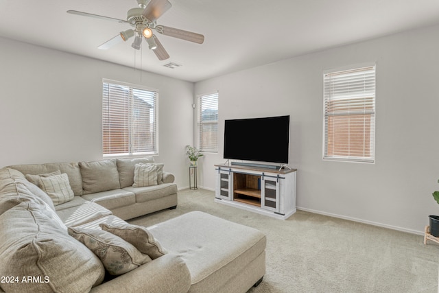 carpeted living room with ceiling fan