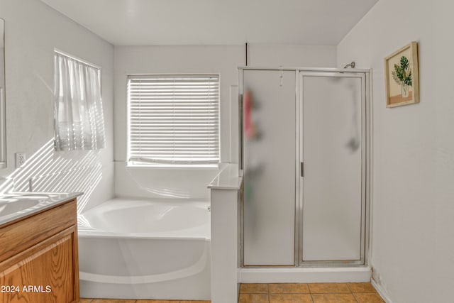 bathroom featuring vanity, tile patterned flooring, and separate shower and tub