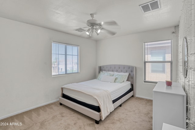 bedroom with light carpet and ceiling fan