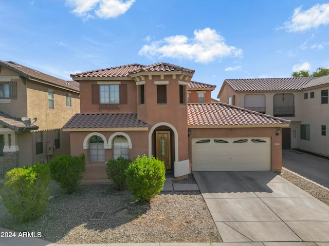 mediterranean / spanish house featuring a garage