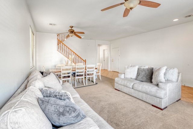 tiled living room with ceiling fan