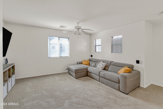 living room featuring ceiling fan and light colored carpet