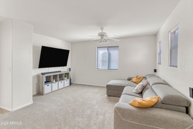 carpeted living room with ceiling fan