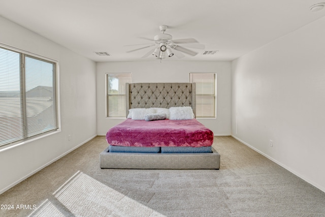 bedroom with ceiling fan and light colored carpet