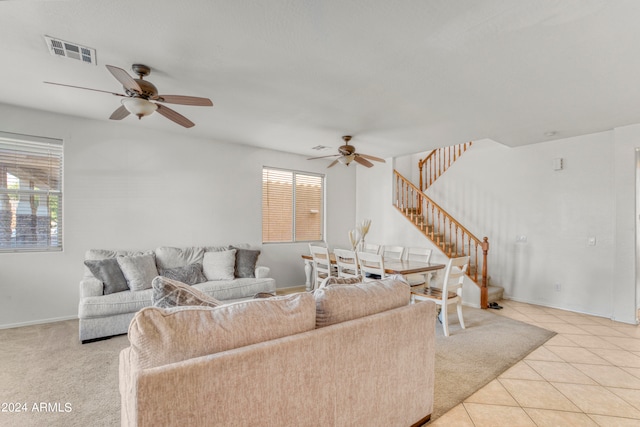 living room featuring ceiling fan and light tile patterned floors