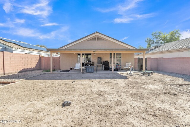 5769 E Good Pasture Ln, Florence, AZ 85132 - back of house with stucco siding, a patio, and a fenced backyard