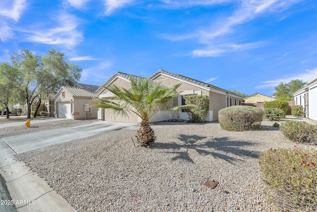 5769 E Good Pasture Ln, Florence, AZ 85132 - view of front of property with driveway, stucco siding, a garage, and a tiled roof