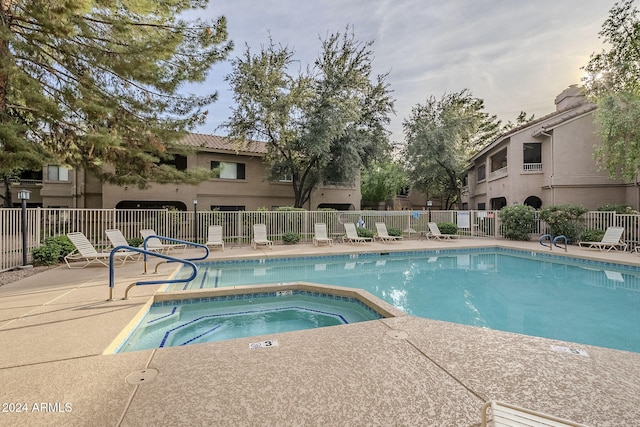 view of pool with a patio and a hot tub