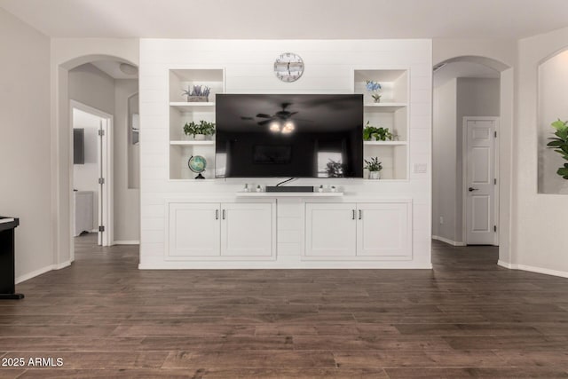 3719 E Sandy Way, Gilbert, AZ 85297 - living area featuring arched walkways, built in features, dark wood-type flooring, and ceiling fan