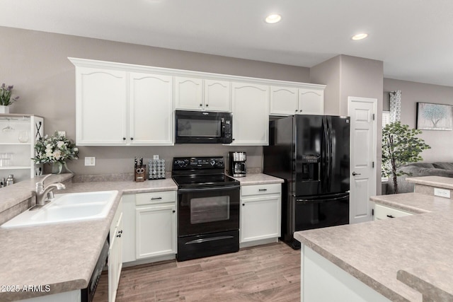 3719 E Sandy Way, Gilbert, AZ 85297 - kitchen featuring black appliances, white cabinetry, light wood finished floors, light countertops, and recessed lighting