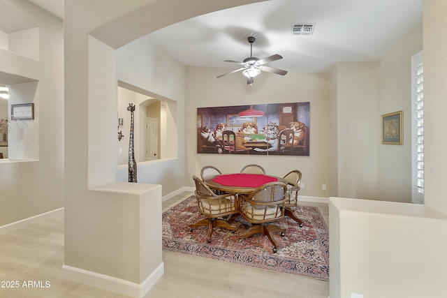 dining room with light hardwood / wood-style floors and ceiling fan