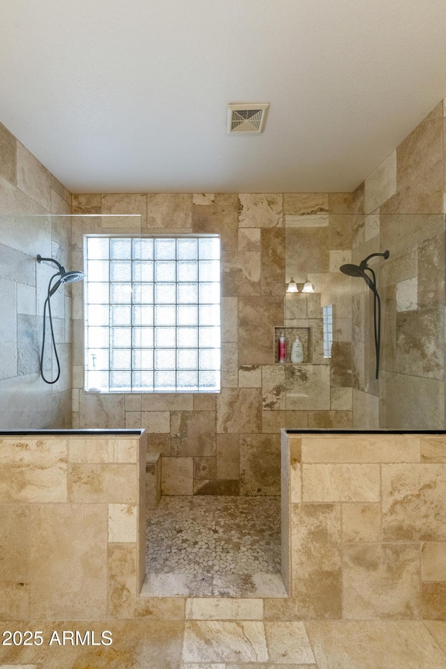 bathroom featuring tiled shower