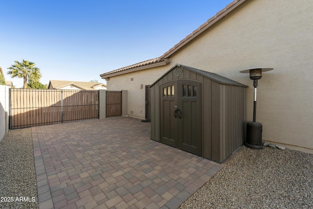 view of patio featuring a shed