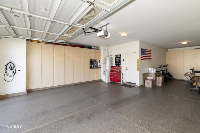 garage featuring a garage door opener and water heater