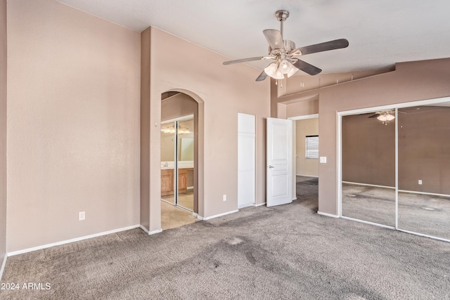 unfurnished bedroom with ceiling fan, carpet floors, and a closet