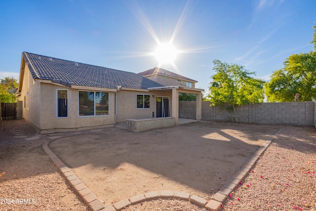 back of property with a patio