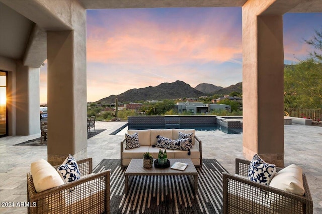 patio terrace at dusk featuring outdoor lounge area and a mountain view