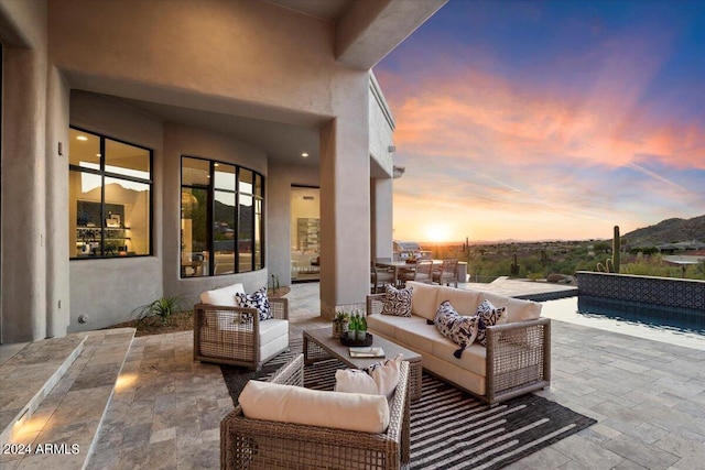 patio terrace at dusk featuring outdoor lounge area