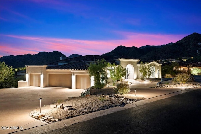 view of front of property featuring a mountain view and a garage