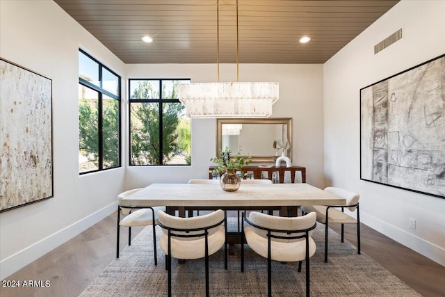 dining area with wooden ceiling, dark wood-type flooring, a healthy amount of sunlight, and a chandelier