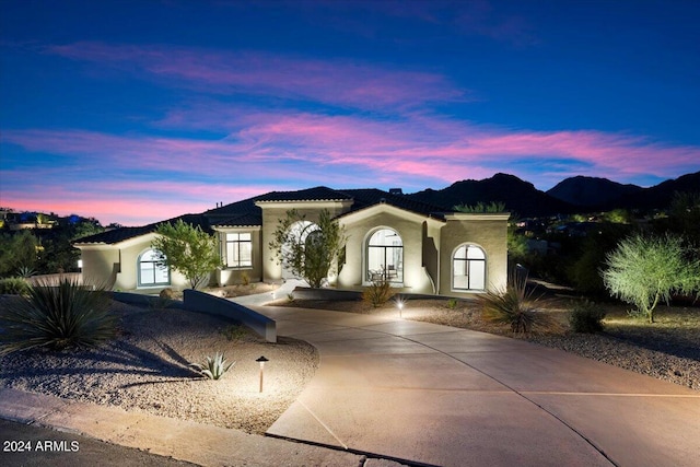 mediterranean / spanish-style house featuring a mountain view and french doors