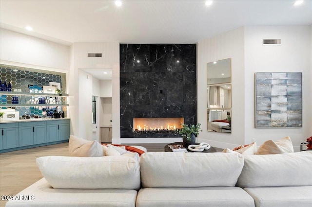 living room featuring light hardwood / wood-style flooring and a premium fireplace