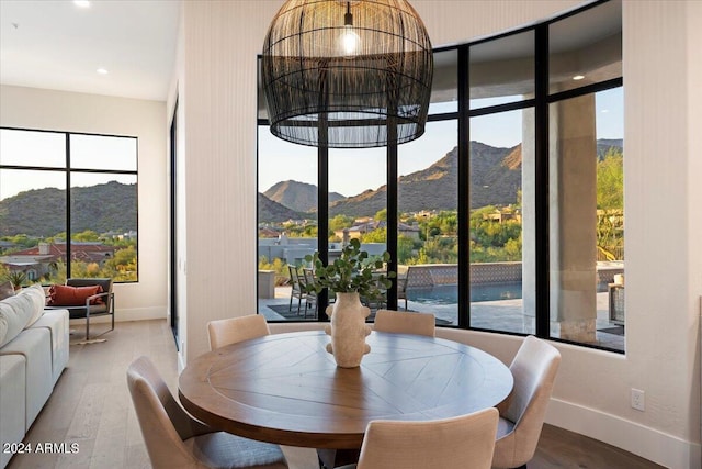 dining room featuring a mountain view and hardwood / wood-style flooring