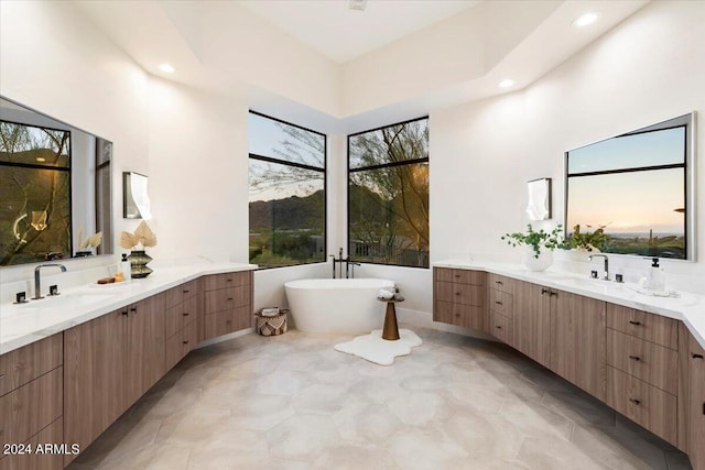 bathroom featuring vanity and a tub