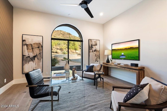 living area with ceiling fan and hardwood / wood-style flooring