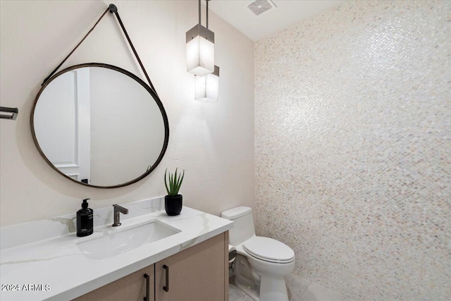 bathroom featuring tile patterned flooring, vanity, and toilet