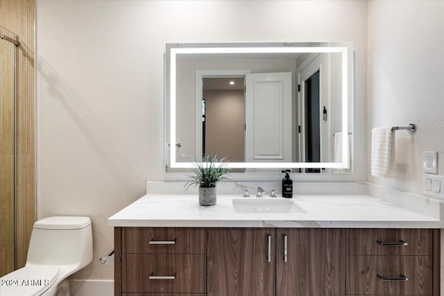 bathroom featuring vanity and toilet