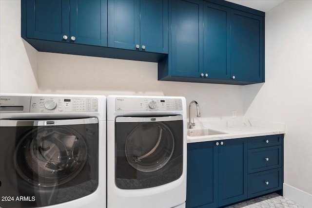 washroom with independent washer and dryer, cabinets, and sink