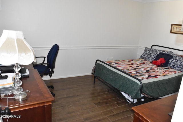 bedroom with baseboards and wood finished floors