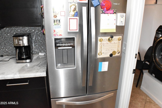 kitchen with tile patterned flooring, stainless steel fridge, and light stone countertops