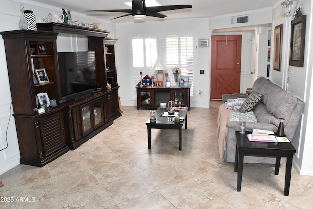 living room with baseboards, crown molding, visible vents, and a ceiling fan