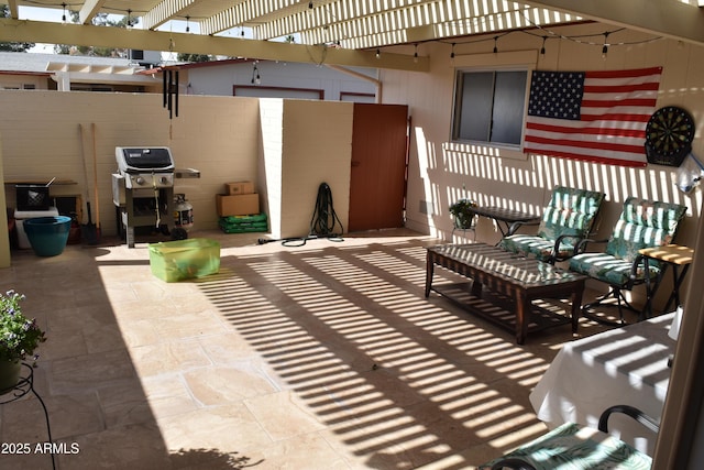 view of patio featuring a grill, fence, and a pergola