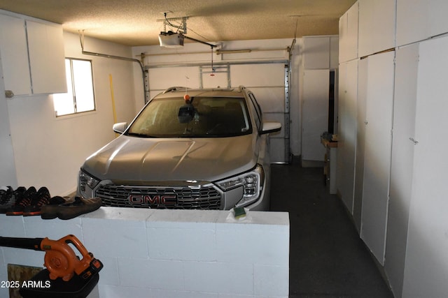 garage featuring a garage door opener and concrete block wall