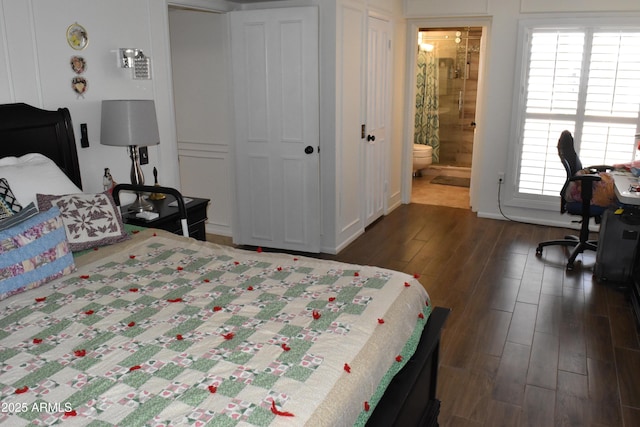 bedroom featuring dark wood-style floors, connected bathroom, and a closet