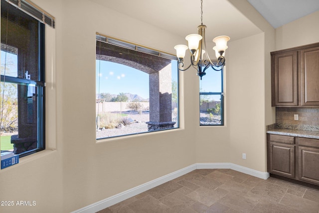 unfurnished dining area featuring an inviting chandelier