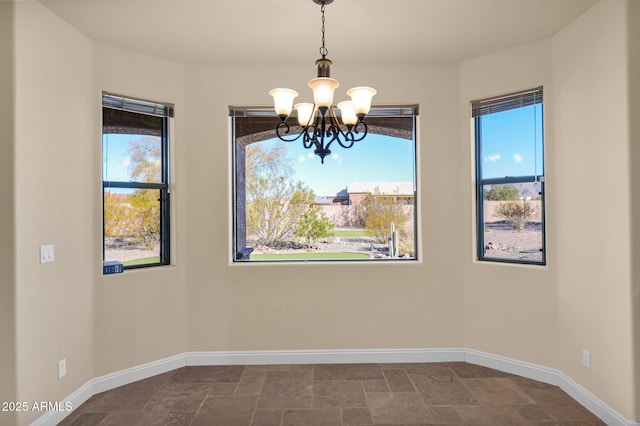 unfurnished dining area with an inviting chandelier