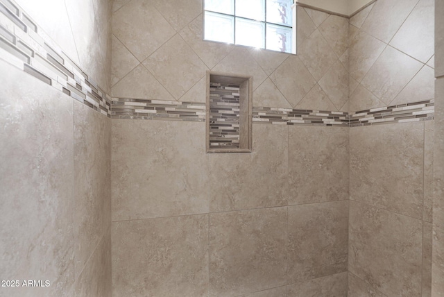 bathroom with a tile shower