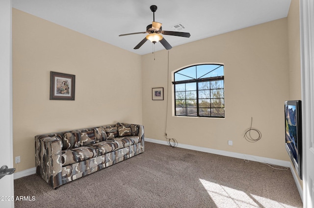 sitting room with ceiling fan and carpet flooring