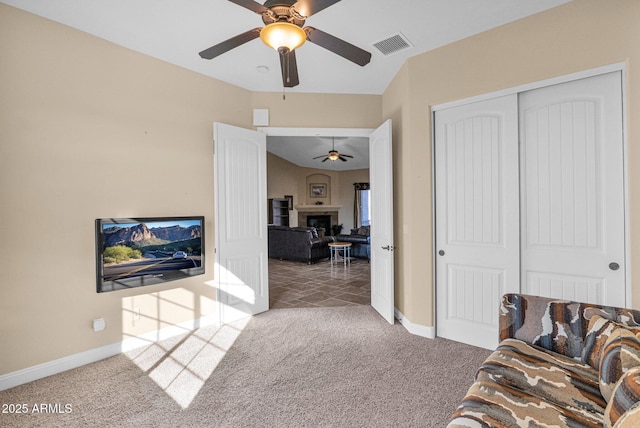 living room featuring carpet flooring and ceiling fan