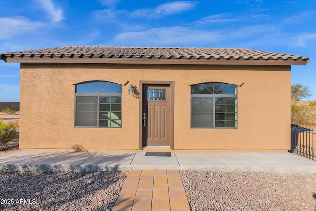 view of exterior entry featuring a patio